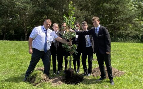 Students plant an oak tree with the Principal